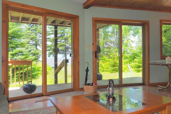 Check out the view from the living room sofa: across the lower deck and out to the lake.