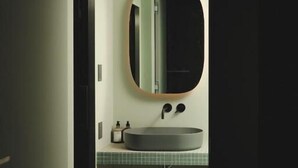 A bathroom with a round mirror, a sink, and a tiled floor. - MU HEN KO Tokyo (Tokyo)