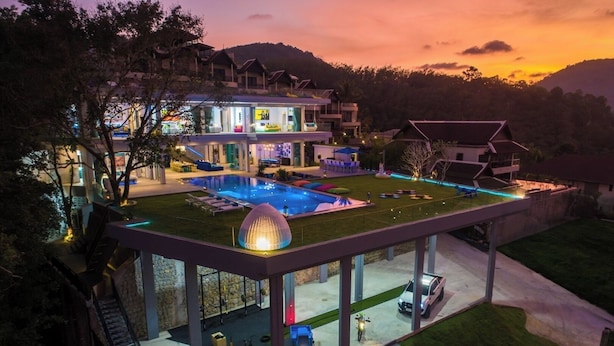 Uma villa moderna com piscina, área de estar externa e terraço envidraçado.