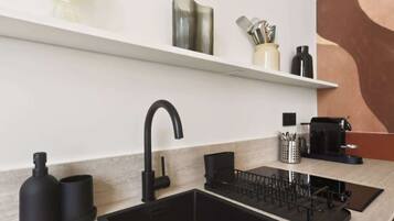 Coffee/tea maker, toaster, cookware/dishes/utensils, dining tables