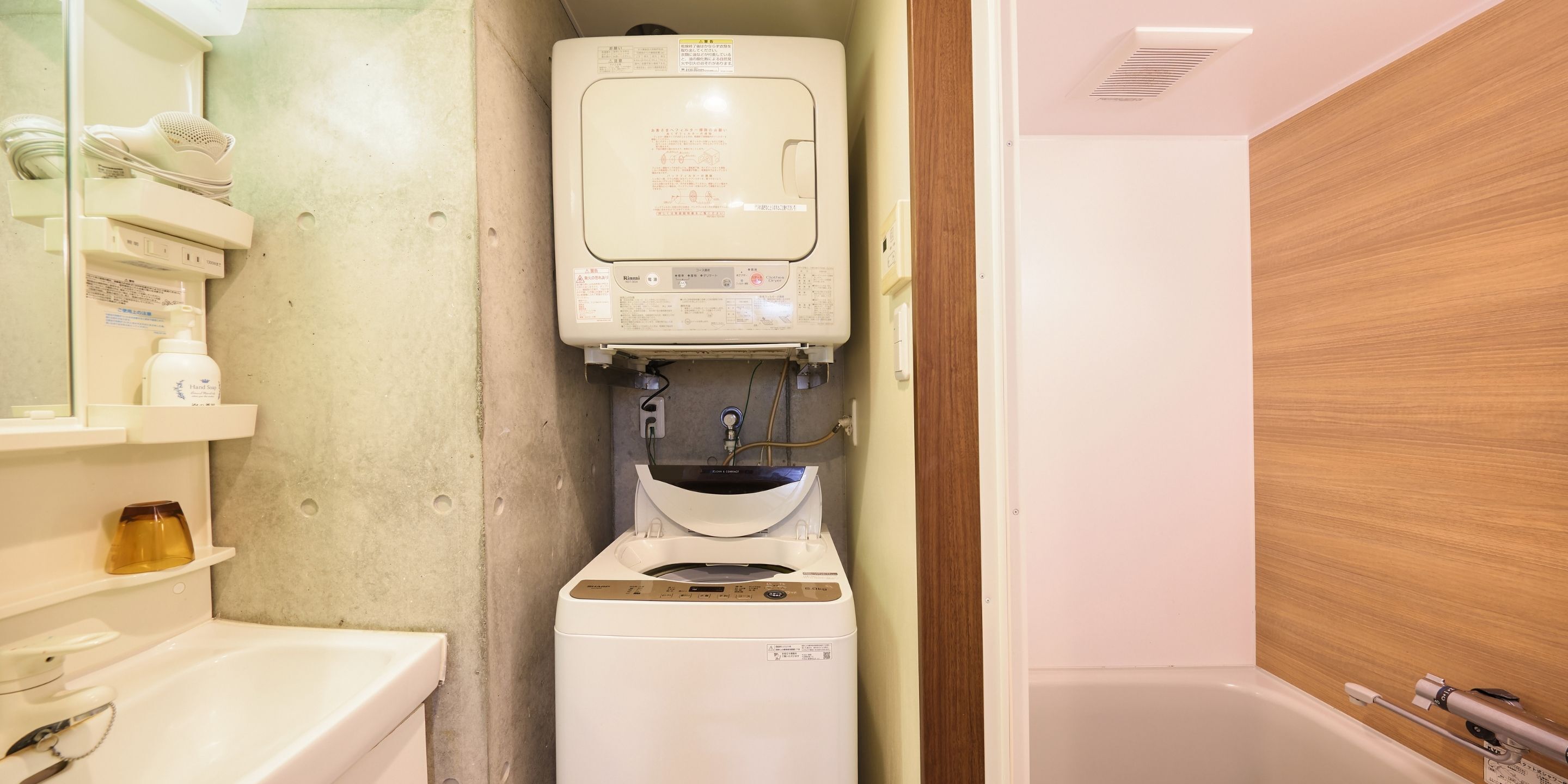 A compact bathroom with a toilet, a small sink, and a mirror.