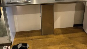 A compact kitchen with a built-in stove, a sink, and a small countertop. - New Normal Hotel in NAHA WAKASA (Naha)