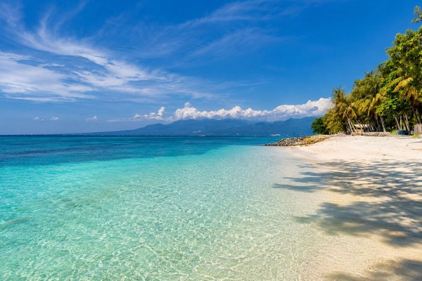 On the beach, white sand, sun loungers, beach umbrellas