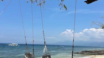 On the beach, white sand, sun-loungers, beach umbrellas