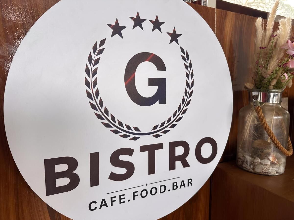 A circular sign with the text 'BISTRO' and 'CAFE.FOOD.BAR' indicating the establishment's name.
