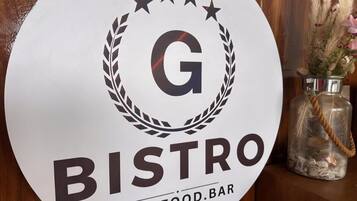 A circular sign with the text 'BISTRO' and 'CAFE.FOOD.BAR' indicating the establishment's name.