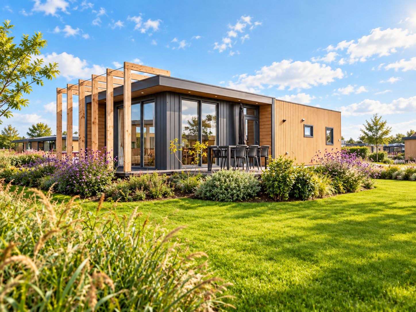 A modern house with a deck, surrounded by a well-maintained garden.