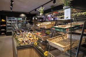 A bakery display with various baked goods and a payment solutions sign.
