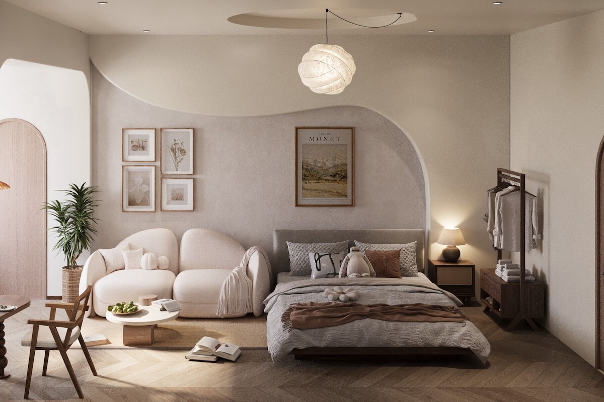 Une chambre à coucher avec un lit, un canapé, une table de chevet avec une lampe, un tableau encadré au mur et une plante en pot.