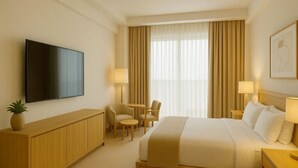 A hotel room with a bed, a TV, a desk, and a chair. - Hotel with 5 bedrooms and AC in fantastic Lipa City (Lipa City)