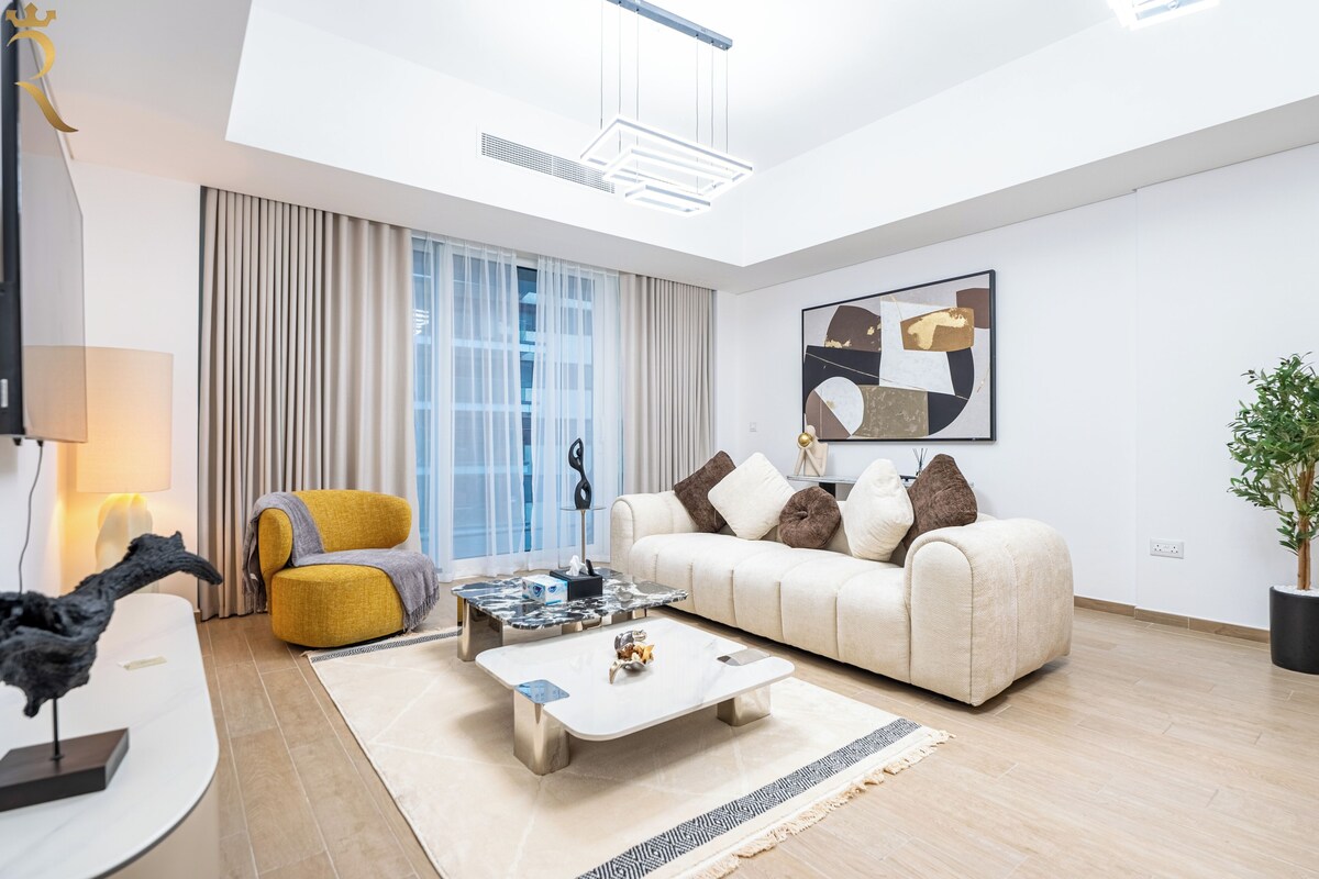 A modern living room with a sofa, coffee table, and a lamp.