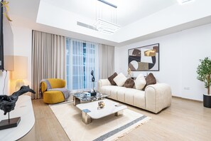A modern living room with a sofa, coffee table, and a lamp.