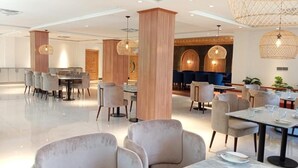 A spacious hotel lobby with modern furniture, a central seating area, and decorative lighting. - IFQ Premier Skardu (Skardu)
