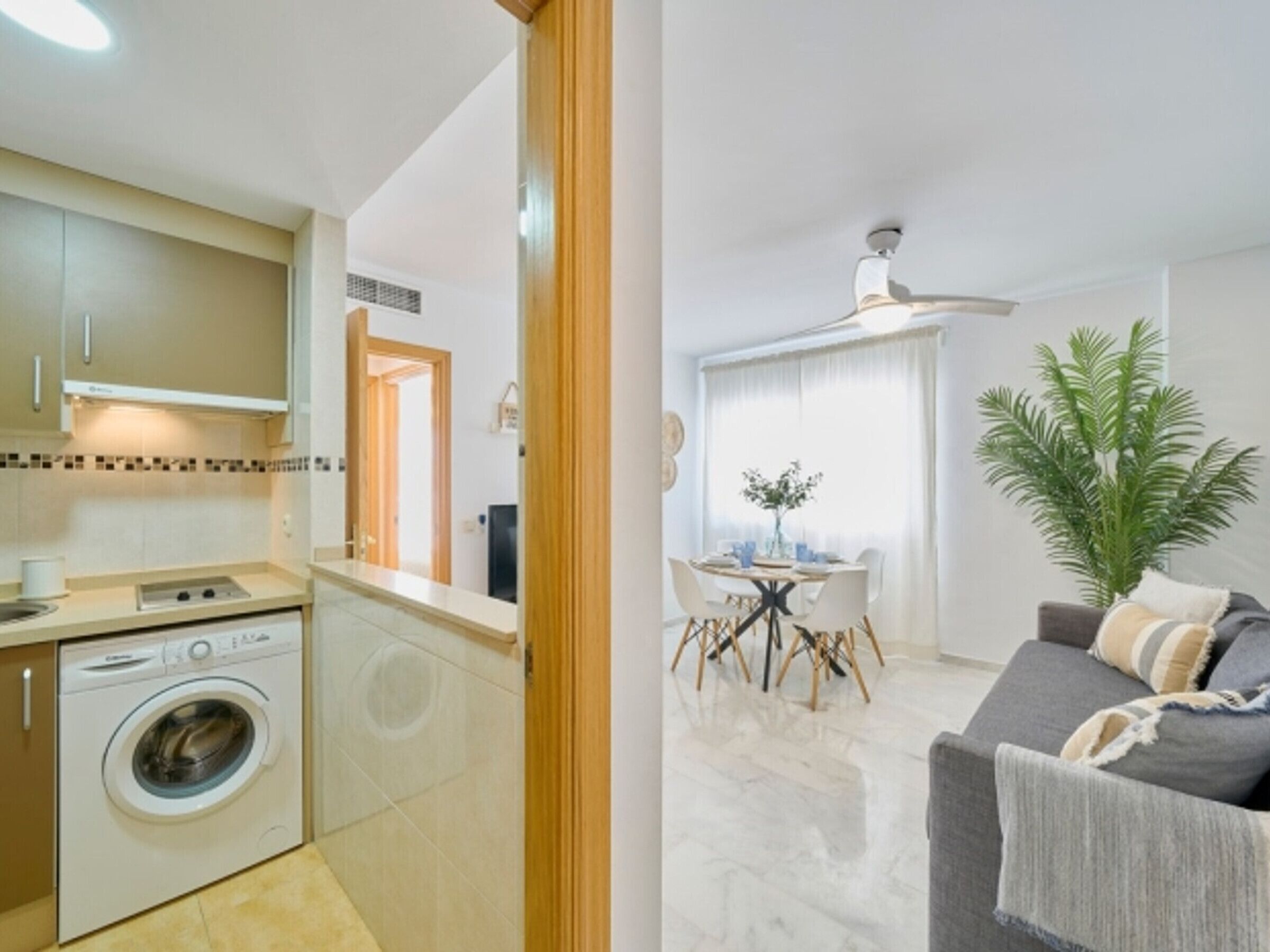 A modern apartment with a kitchen, dining area, and living room.