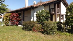 A two-story house with a brown roof, white walls, and a chimney. There are two satellite dishes on the roof and a small balcony on the second floor. - Peaceful villa with pool, pets welcome - 8 guests (Vielle-Saint-Girons)