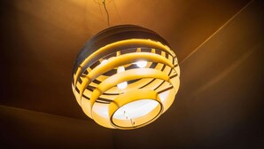A spherical ceiling light fixture with multiple concentric rings. - 1-bedroom Apartment in National Residence (Antwerp)
