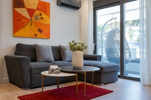 Deluxe Apartment, Balcony | Living area | 50-inch Smart TV with satellite channels, streaming services