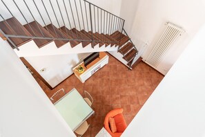 A modern interior with a staircase, a dining area, and a kitchen. - Gem of Mondello by Wonderful Italy (Palermo)