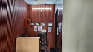 A reception area with a wooden reception desk, a black office chair, a trash bin, and several signs on the wall. - Hotel Royal Residency (New Delhi)