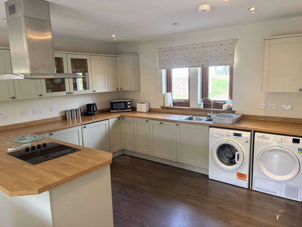 A modern kitchen with a built-in microwave, toaster, and sink.