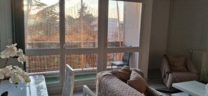A room with a large window, a chair, a bed, and a table. - Large, Entire Apartment Near Paris (Creil)