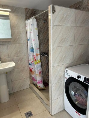 Shower, hair dryer, towels, toilet paper