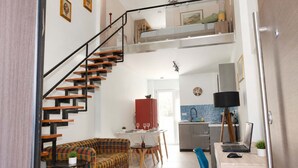 A modern apartment with a staircase, a dining area, a kitchen, and a workspace. - Athens Mets Loft - Cozy Urban Gem Park Views (Athens)