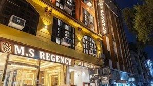 A building with 'M.S. REGENCY' signage, multiple balconies, and a well-lit entrance. - MS REGENCY (New Delhi)