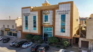 A hotel with a modern design, featuring a prominent logo and signage for 'Quiet Rooms.' - Quiet Rooms 14  (Riyadh)