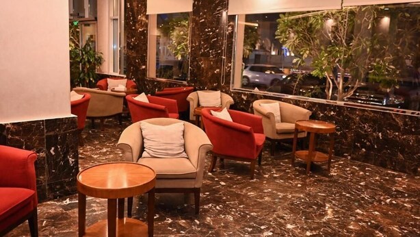 A lobby with seating, a marble floor, and a view through large windows. - Quiet Rooms 14  (Riyadh)