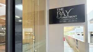 A modern hotel lobby with a sign reading 'The Bay Apartment Main Lobby.' - 2-bedroom apartment in Bandar Lampung with Mall Access (Bandar Lampung)