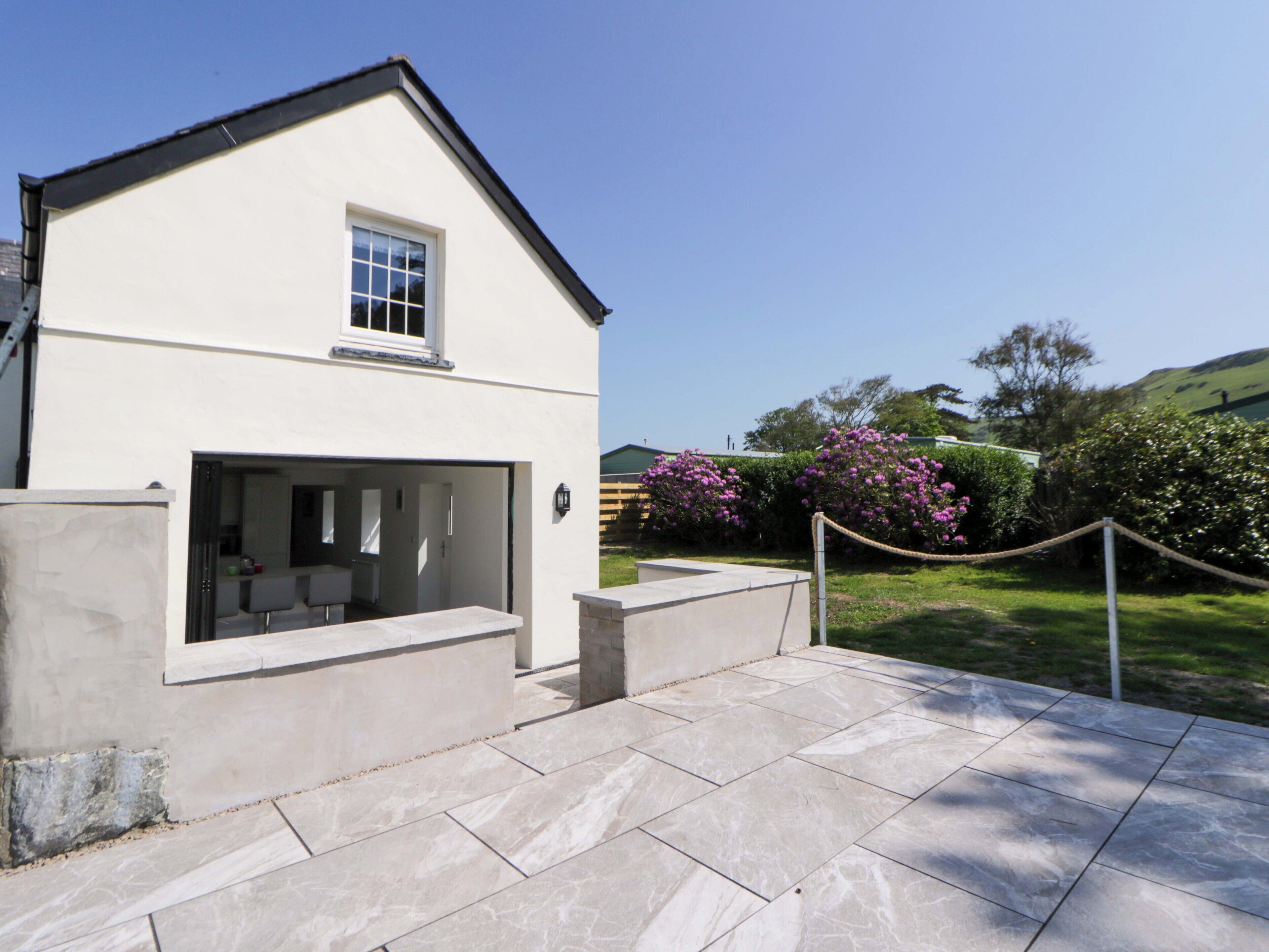 A modern two-story house with a patio area.