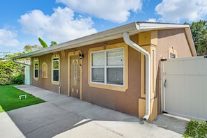 A residential house with a front garage, a well-maintained lawn, and a clear sky.
