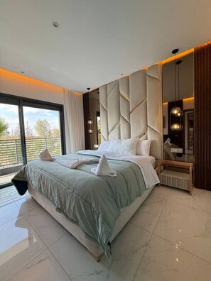 A modern bedroom with a large bed, a view of the outdoors, and a built-in wardrobe. - Pool • Retreat at Villa Taroub • 4 Suits • Gym (Marrakesh)