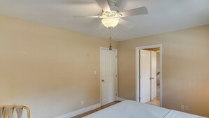 A bedroom with a bed, a ceiling fan, and a door leading to another room. - Amazing Mtn & City Views! Simi Valley Hideaway (Simi Valley)