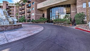 A multi-story building with balconies, a large entrance, and a stone sculpture. - Golf, Boat, Swim! Walkable Lake Havasu Getaway (Lake Havasu City)