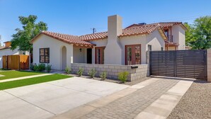 A modern two-story house with a tiled roof, a brick chimney, and a gated driveway. - Easy Dtwn Access! Prime PHX Stay For Couples (Phoenix)