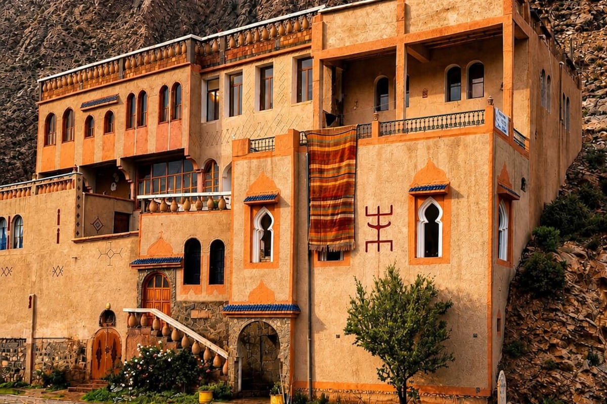 A traditional building with multiple windows and a staircase leading to an entrance.