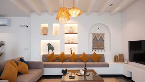 A modern living room with a sofa, coffee table, and decorative lighting.