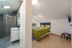 A bedroom with a bed, a window, a bedside table, and a small stool. - Villa Flora Zadar Villas (Benkovac)