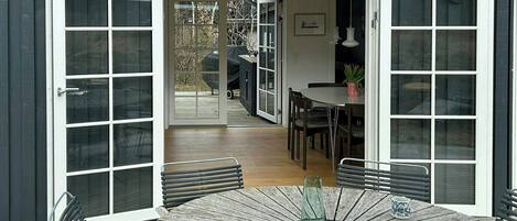A dining area with a round table, chairs, and a magazine.