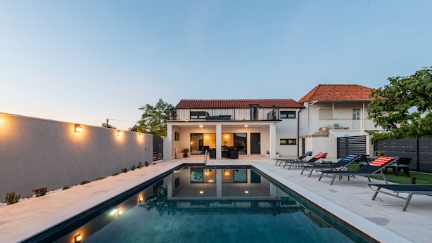 A modern house with a swimming pool, outdoor seating, and a well-maintained garden. - Villa Flora Zadar Villas (Benkovac)