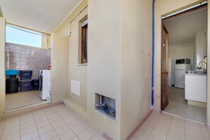 A compact kitchen with a microwave, refrigerator, and sink.