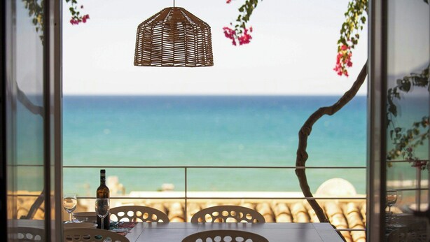 A table with chairs, a bottle, and a glass, overlooking the sea. - Villa with terraces on Castellammare Gulf (Alcamo)
