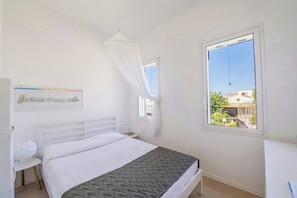 A bedroom with a bed, a bedside table, a window, and a curtain. - Villa with terraces on Castellammare Gulf (Alcamo)