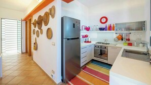 A modern kitchen with a stainless steel refrigerator, a stove, and a sink. - Villa with terraces on Castellammare Gulf (Alcamo)