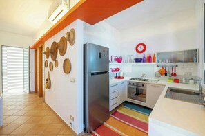 A modern kitchen with a stainless steel refrigerator, a stove, and a sink. - Villa with terraces on Castellammare Gulf (Alcamo)