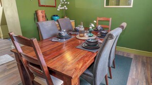 A dining table set with plates, glasses, and a vase with flowers. - Banklands (Barnard Castle)