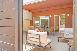 An outdoor patio with a table and chairs, a sofa, and a view of the cityscape. - Modern 2BR Marbella Centre Pool & Terrace (Marbella)