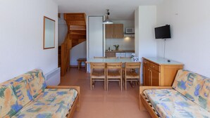 A compact living space with a kitchenette, a dining area, and a sofa. - 6-guest Rental With Dedicated Ski Locker (Germ)